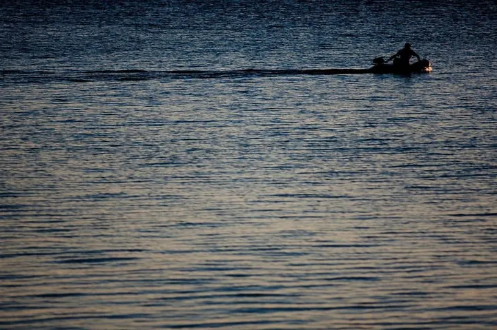 Lone boat on dark water