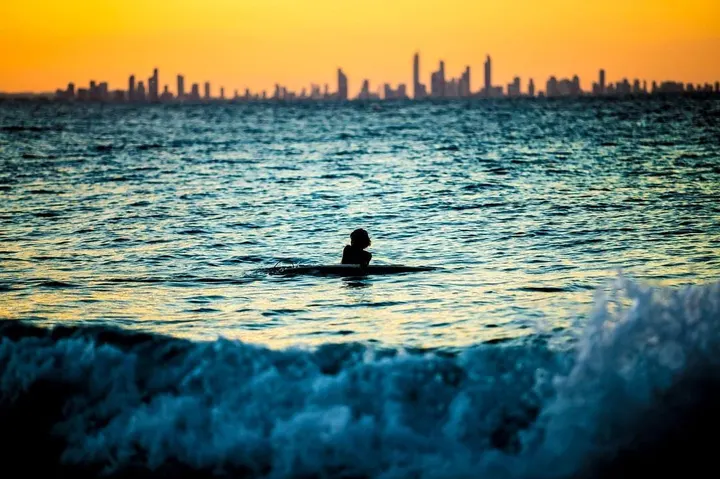 Surfer and skyline glow